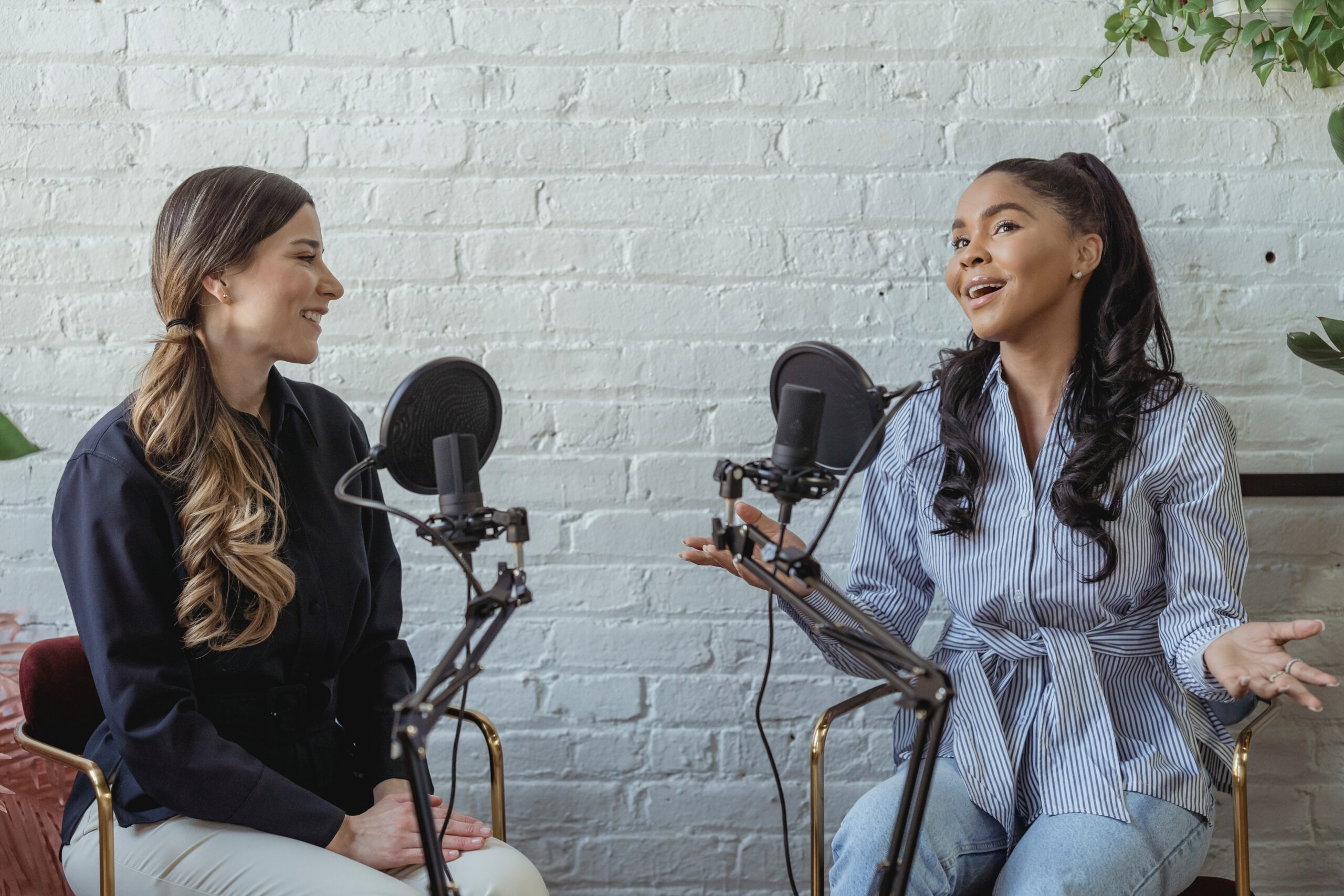 Two women interviewing with microphones