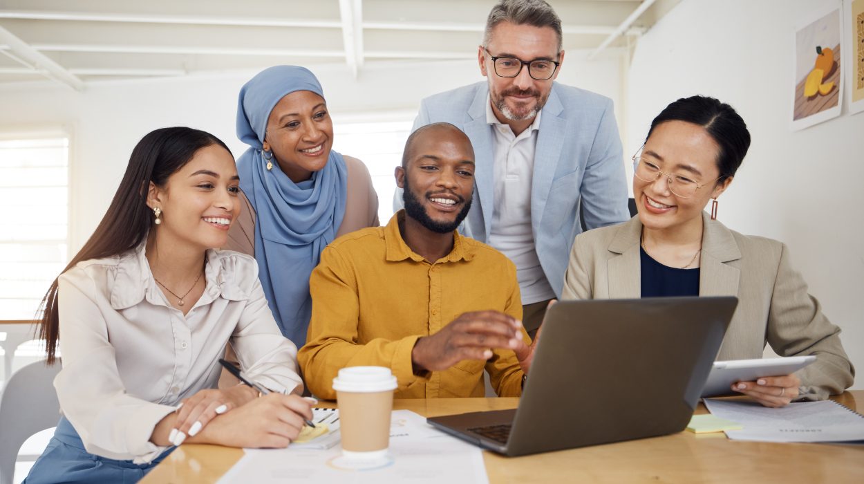 Business people, meeting and laptop for team collaboration planning and website design presentation in office. Diversity group of men and woman on computer for teamwork, marketing training or project