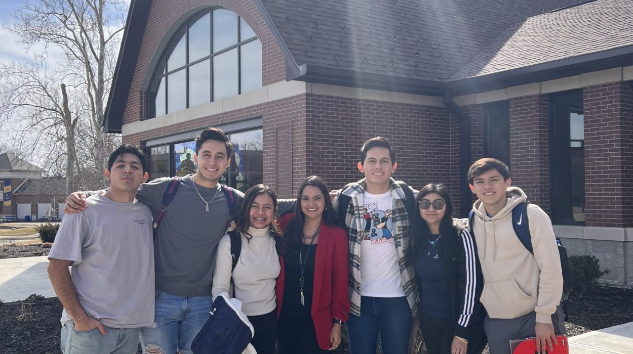 Group of students standing in front of a campus building